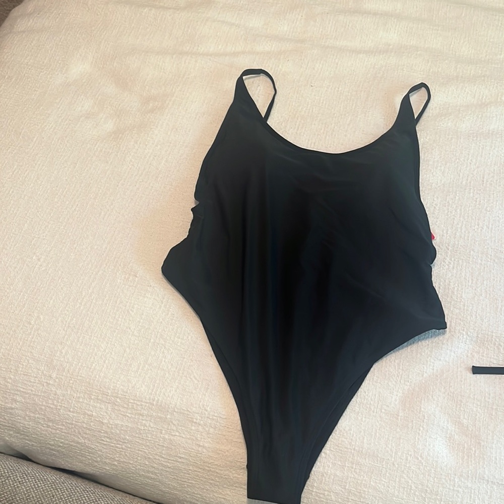 Black high cut one piece swimsuit with a low back